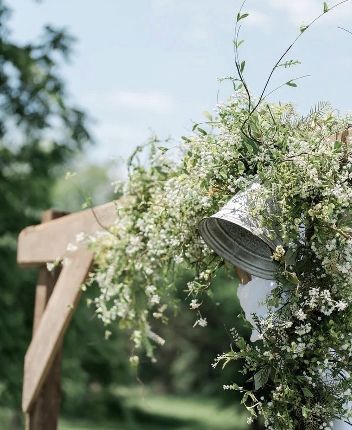 Wedding ceremony arch dressed with white flowers
